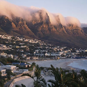 Camps Bay. View from Lions Head along the coastline and the Twelve Apostles mountain cliffs covered in a blanket of cloud