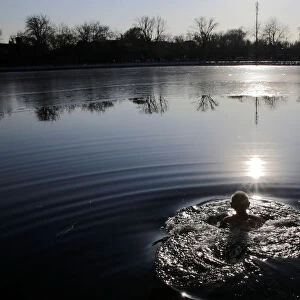 An 89-year-old resident swims in Houhai lake in central Beijing