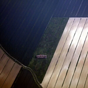 An abandoned building stands in the middle of ploughed fields on the outskirts of Venice