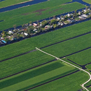 Aerial view of houses surrounded by water near Amsterdam