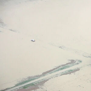 An aerial view shows a blockd car near the flooded airport Berne Belpmoss