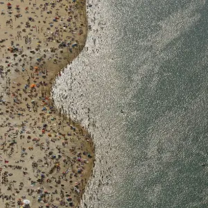 An aerial view shows people at a beach on the shores of the Silbersee lake on a hot