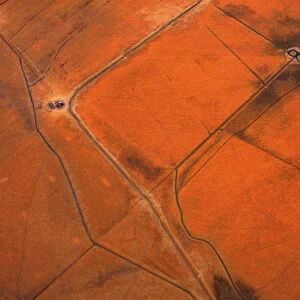 An aerial view of small dams containing water are seen in dry paddocks located north-west