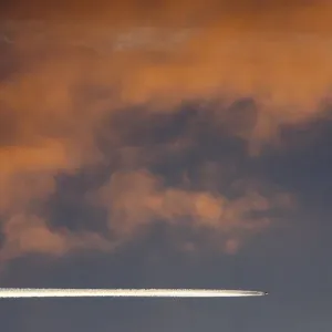An aircraft flies above Russias Siberian city of Krasnoyarsk during sunset An aircraft flies above Russias Siberian city of Krasnoyarsk during sunset