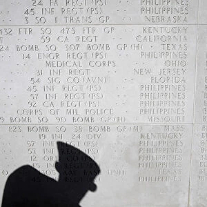 An American views the memorial hall where the names of fallen U