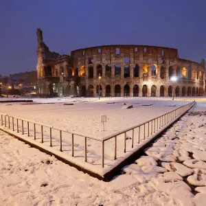 The ancient Colosseum is seen during a heavy snowfall early in the morning in Rome