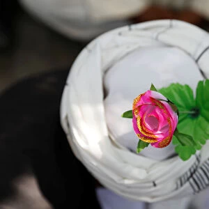 An artificial flower is seen on a turban of a peace marcher as he arrives in Kabul