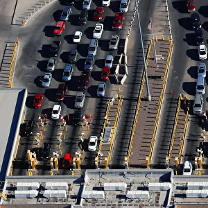 Automobiles pass through the U. S. border and into the United States from Juarez