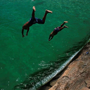 Bathers dive into the sea at the Leme beach in Rio de Janeiro