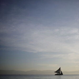 A boat sails next to the shore in Port-au-Prince