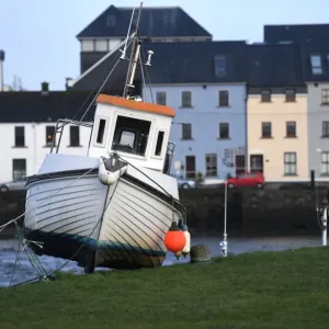 A boat is stranded on the edge of a pier after it was washed there by floods in Galway A boat is stranded on the edge of a pier after it was washed there by floods in Galway