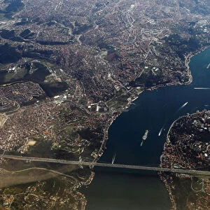 Bosphorus strait and the Fatih Sultan Mehmet bridge are pictured through the window of a