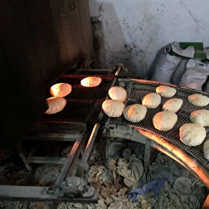 Bread is baked before the time for iftar, or breaking fast, during the Muslim fasting