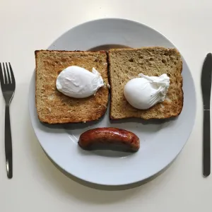 A breakfast of sausage, eggs and toast is pictured in an office canteen in London A breakfast of sausage, eggs and toast is pictured in an office canteen in London