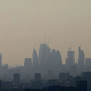 Buildings and construction cranes are seen through a heat haze in London