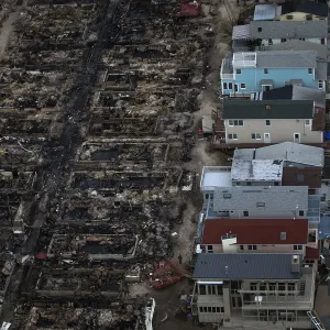 Burned houses are seen next to those which survived in Breezy Point after they were Burned houses are seen next to those which survived in Breezy Point after they were