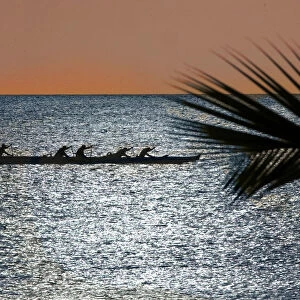 Canoe club members practice in the Pacific Ocean off Haleiwa Hawaii