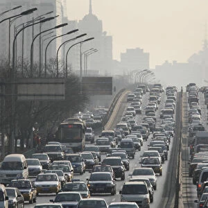 Cars are driven on one of the ring roads in Beijings city centre