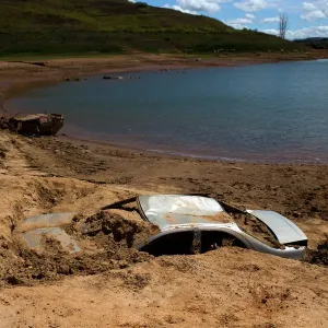 Cars suspected to be stolen and dumped in Jaguari lake appear on dry ground during a Cars suspected to be stolen and dumped in Jaguari lake appear on dry ground during a
