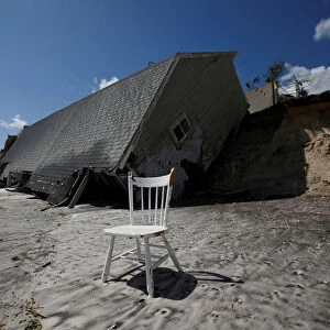 A chair is pictured outside a collapsed coastal house after Hurricane Irma passed the