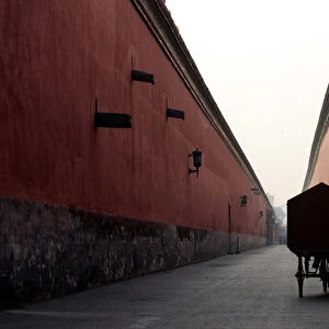A Chinese cyclist pedals inside the Forbidden City in Beijing