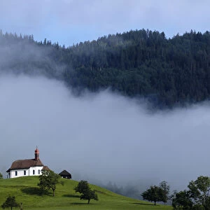 A church is pictured in the early morning on a mountain in Sarnen