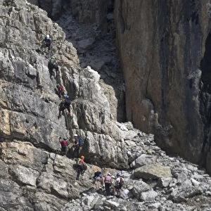 Climbers make their way up a via ferrata to the peak of Piz Da Lech in the Dolomite