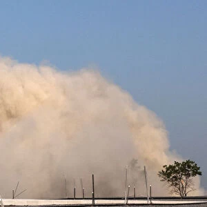 A cloud of dust from a nearby imploded building approaches the Statue of Liberty in New