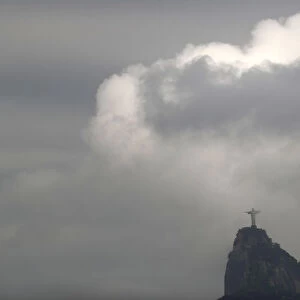 Clouds pass the Christ The Redeemer statue on Corcovado mountain, ahead of the Rio