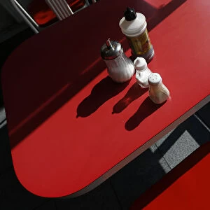 Condiments are seen on a table inside The Arsenal Fish Bar restaurant in north London