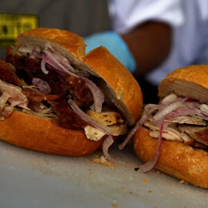 A cook prepares sandwich with grilled pork during Mistura gastronomic fair in Lima