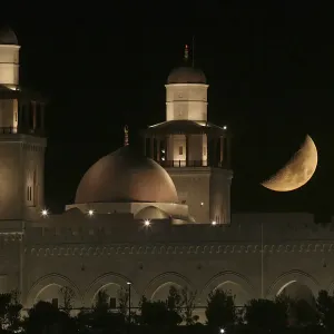 A crescent moon is seen next to the King Hussein Bin Talal Mosque in Amm A crescent moon is seen next to the King Hussein Bin Talal Mosque in Amm
