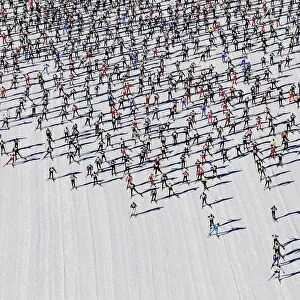 Cross-country skiers start during the Engadin Ski Marathon on the frozen Lake Sils