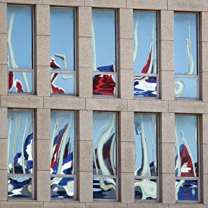 Cuban flags are reflected of the windows of the Interests Section Office of the United