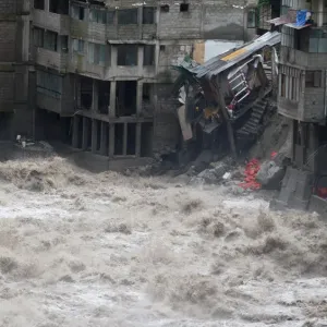 Damaged buildings, including hotels, are flooded by the Vilcanota river in Machu Picchu