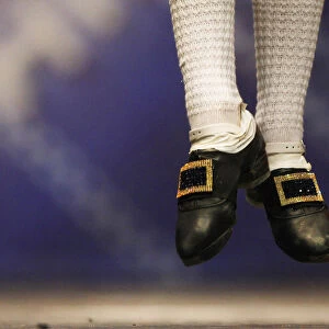 A dancers jumps in a heat during the All Scotland Championships in Irish Dancing at