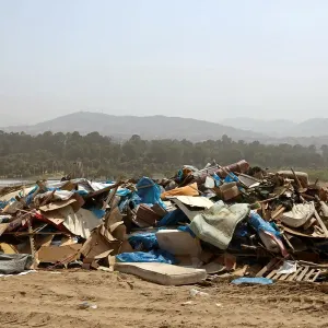 Debris of huts are seen after police evict squatters from a land in Villa El Salvador
