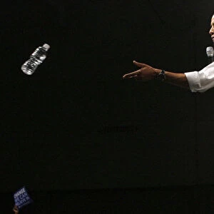 Democratic presidential candidate Senator Barack Obama throws a bottle of water to