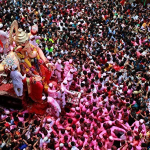 Devotees carry an idol of Hindu god Ganesh during a procession on the last day of