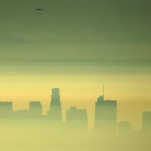 Downtown Los Angeles and an airplane are seen through the morning marine layer in Downtown Los Angeles and an airplane are seen through the morning marine layer in