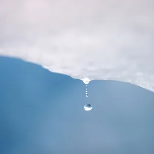 A drop of water falls from a melting piece of ice on Argentinas Perito Moreno glacier A drop of water falls from a melting piece of ice on Argentinas Perito Moreno glacier