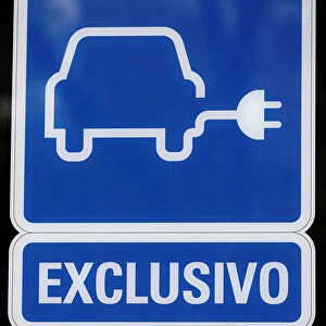Electric car charging sign is pictured at a charging point for electric vehicles in