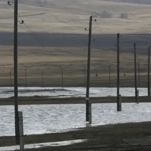 Electricity pylons are seen on the flooded banks of a lake in the Siberian village of Electricity pylons are seen on the flooded banks of a lake in the Siberian village of