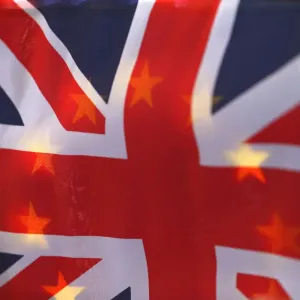 An EU flag is seen through a British Union flag during a pro-EU referendum event