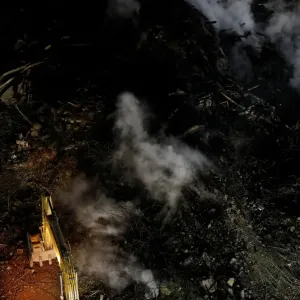 Excavator removes debris of a building that caught fire Excavator removes debris of a building that caught fire