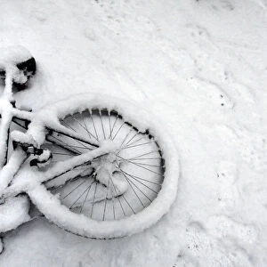 A fallen bicycle lies in the snow in Cambridge in eastern England
