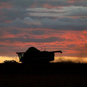 A farmer works with his tractor on a field near Brasilia