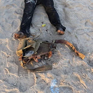 The feet and utility belt of what Ivorian security officers said was a dead attacker is