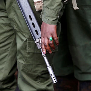 A female wildlife ranger holds a rifle during the launch of a rhino ear notching exercise