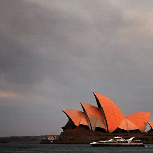 Ferry sails past the Sydney Opera House as smoke from bushfires can be seen above